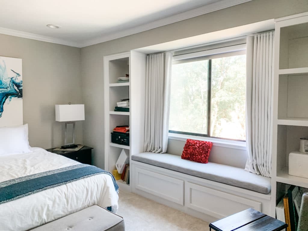 Ripplefold blackout drapes layered with blackout honeycombs transform thos bedroom in a nap haven in Richmond