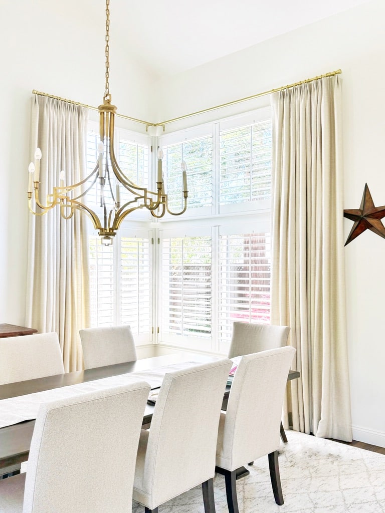 While shutters are functional, this dining room would feel cold without the addition of the drapes.